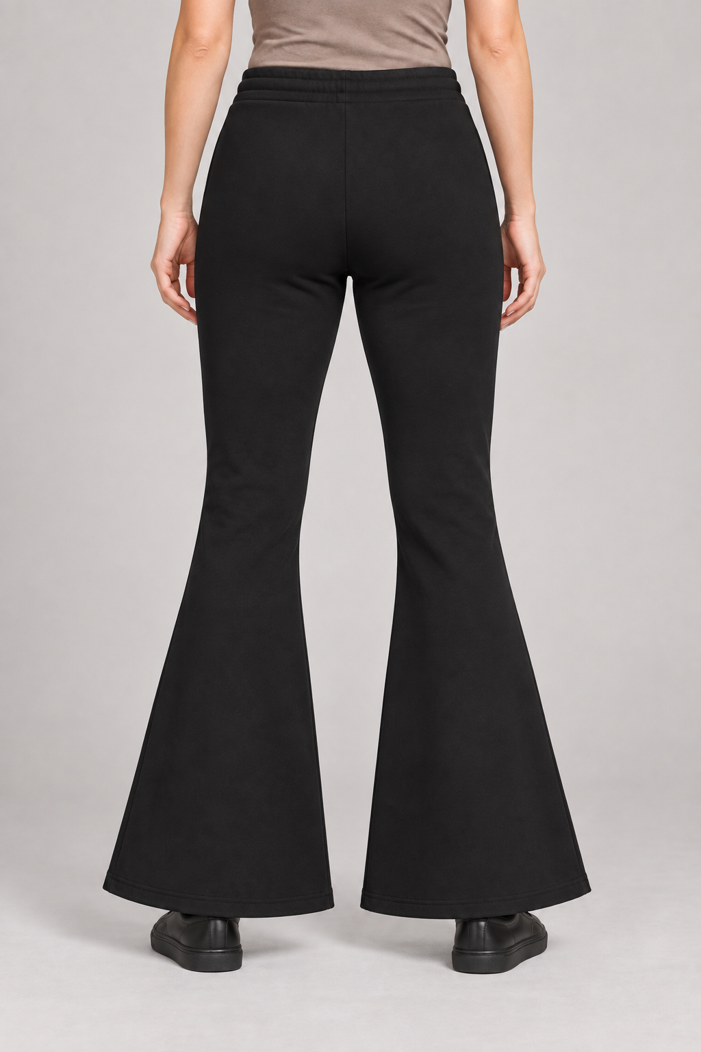 Rear view of Quiet Bell Flared Sweatpants in Black, showing the plain back and clean flared hems.
