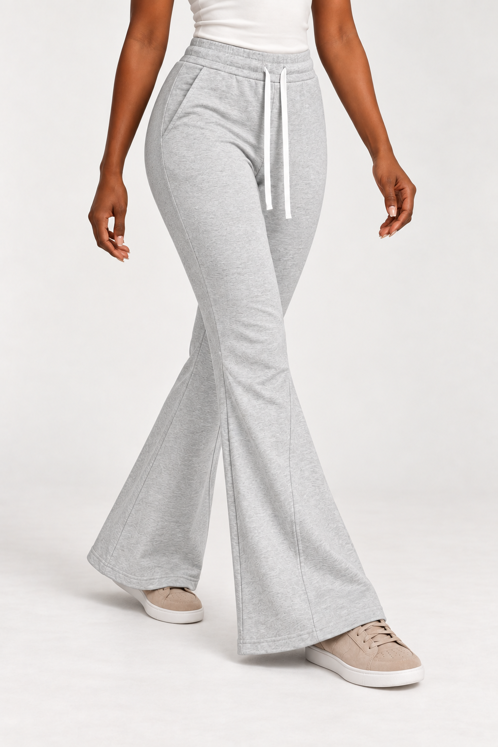 Three-quarter view of Quiet Bell Flared Sweatpants in Flower Gray, showing slash pockets and the shaped lower legs.