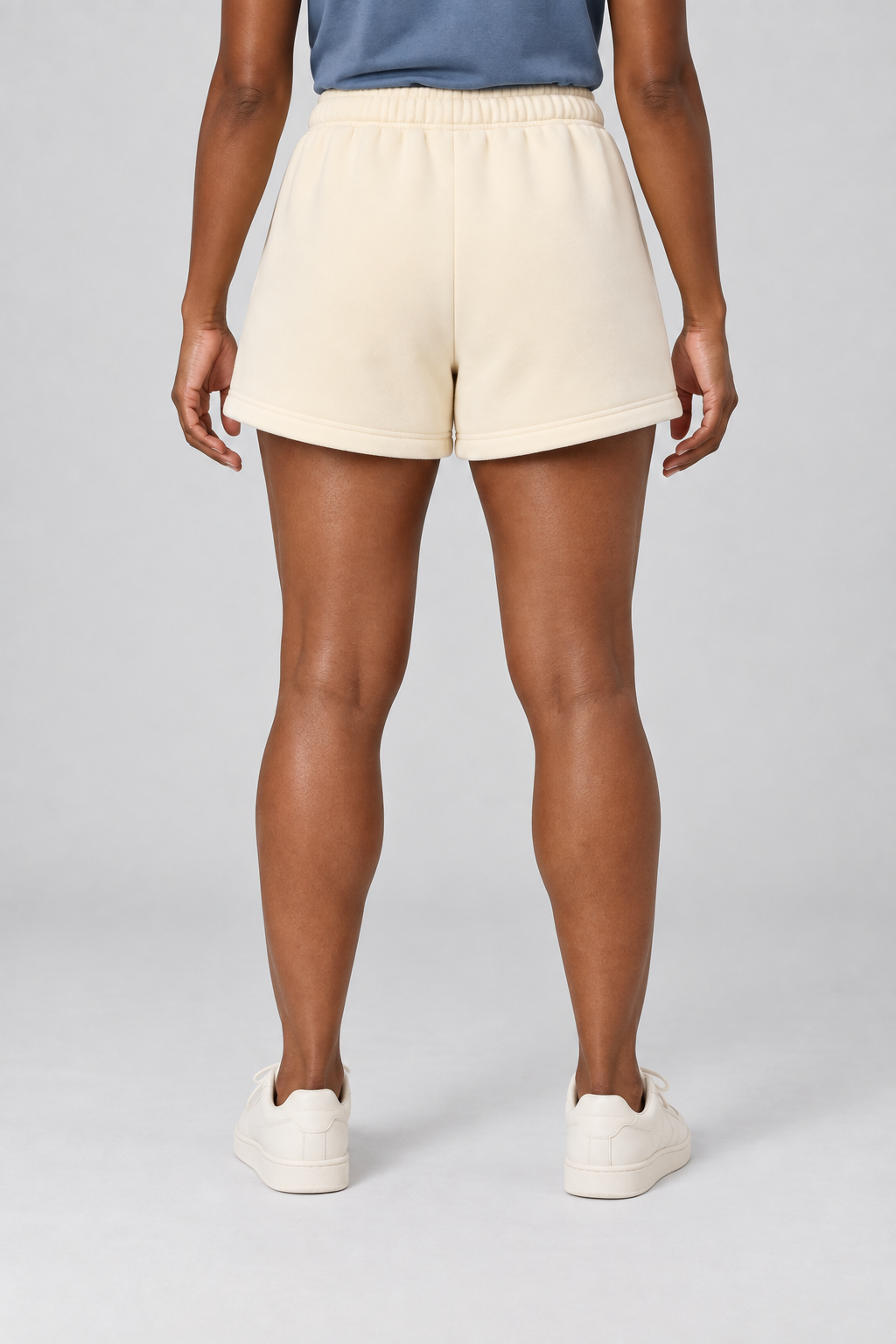 Rear studio view of Slow Morning Fleece Sweatshorts in Cream Apricot, showing the plain back and clean stitched hems.