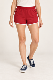 Front studio view of Track Echo Contrast Shorts in Red, showing slash pockets and white hem binding.