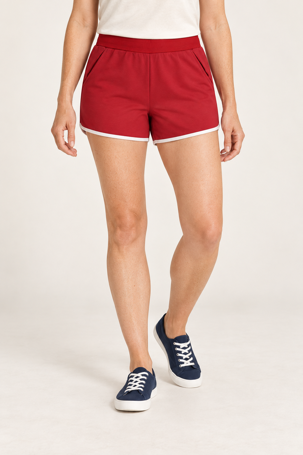 Front studio view of Track Echo Contrast Shorts in Red, showing slash pockets and white hem binding.