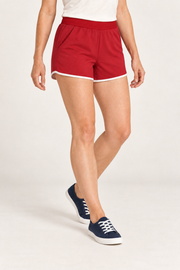 Three-quarter studio view of Track Echo Contrast Shorts in Red, showing the elastic waist, side pocket and contrast hems.