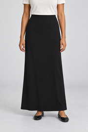 Front studio view of Quiet Column Knit Maxi Skirt in Black, showing the plain long silhouette and simple elastic waist.