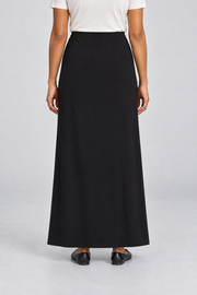 Rear studio view of Quiet Column Knit Maxi Skirt in Black, showing the uninterrupted back and smooth knit drape.