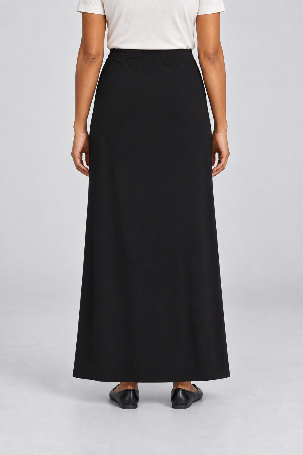 Rear studio view of Quiet Column Knit Maxi Skirt in Black, showing the uninterrupted back and smooth knit drape.