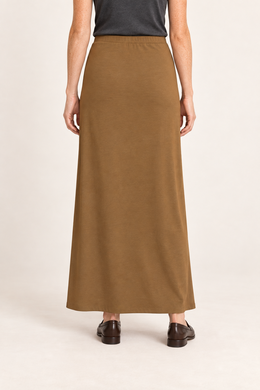 Rear studio view of Quiet Column Knit Maxi Skirt in Brown, showing the uninterrupted back and smooth knit drape.