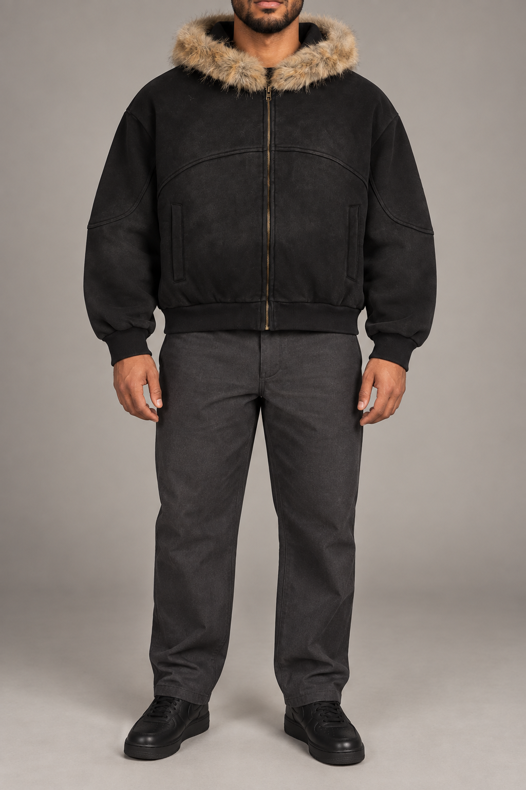 Front view of Dusk Shelter Boxy Zip Hoodie in Black with tan fur trim, curved seams and full zip.