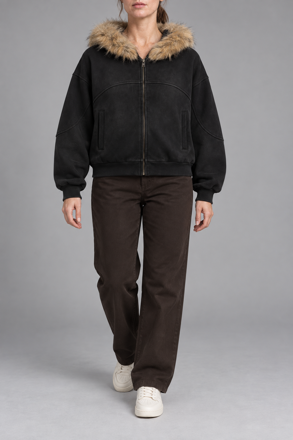 Front view of Night Shelter Boxy Zip Hoodie in Black with tan fur trim, curved seams and full zip.