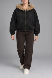 Front view of Night Shelter Boxy Zip Hoodie in Black with tan fur trim, curved seams and full zip.