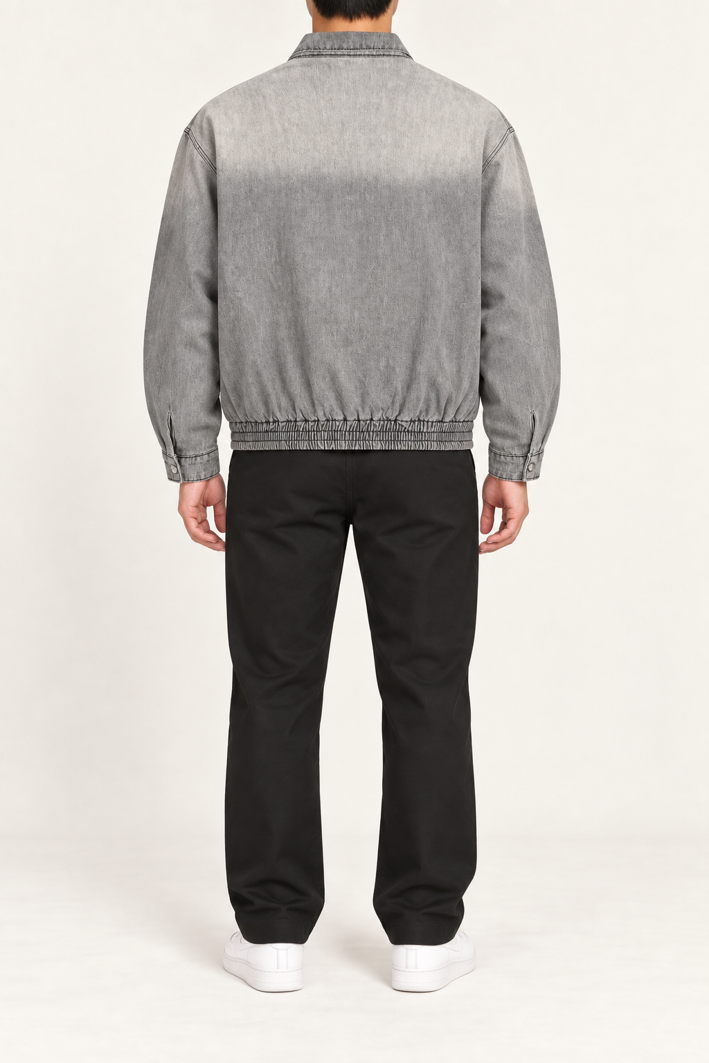 Rear view of Silver Hour Zip Denim Jacket in Light Gray showing the plain washed back, elastic hem and button cuffs.