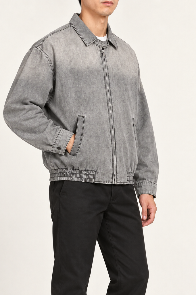 Three-quarter view of Silver Hour Zip Denim Jacket in Light Gray showing its relaxed shape and topstitched seams.