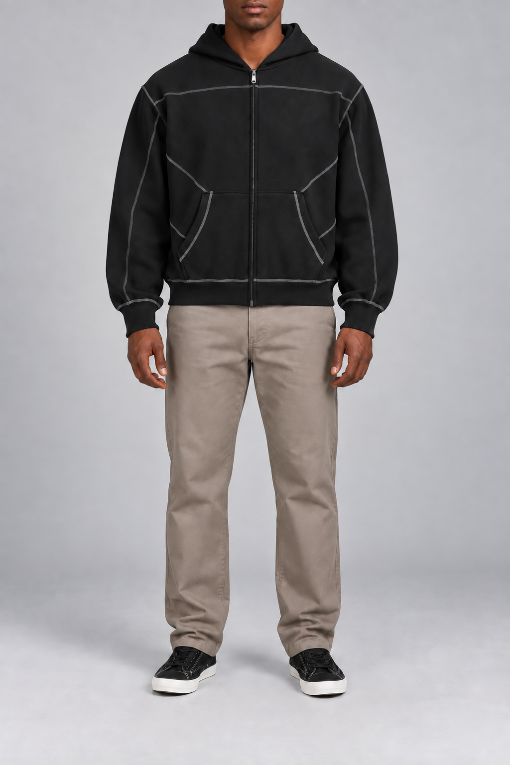 Front view of Outline Studio Fleece Zip Hoodie in Black showing contrast stitching, full zip and pouch pockets.