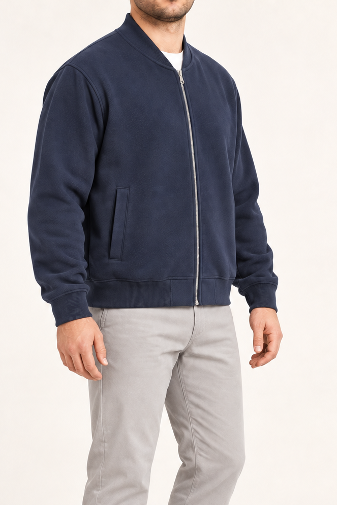 Three-quarter view of Campus Still Fleece Varsity Jacket in Navy showing its relaxed sleeves and clean silhouette.