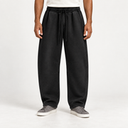 Front view of After Hours Barrel Fleece Sweatpants in Black showing the drawstring waist, pleats and knee shaping.