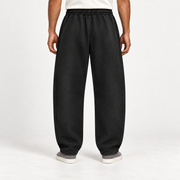 Rear view of After Hours Barrel Fleece Sweatpants in Black showing the plain back and curved leg silhouette.