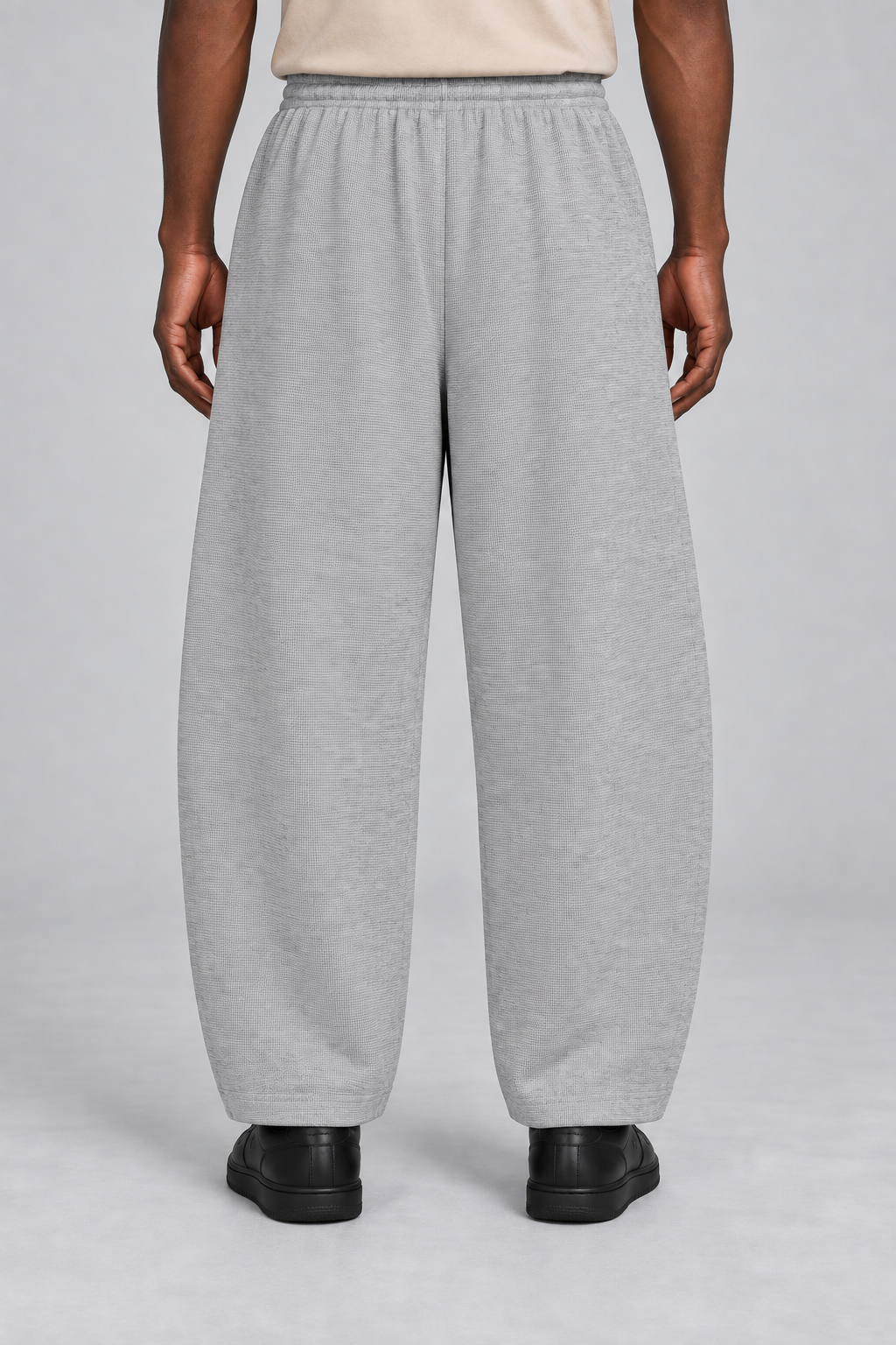 Rear view of Soft Grid Waffle Barrel Pants in Flower Gray showing the plain back and softly curved legs.