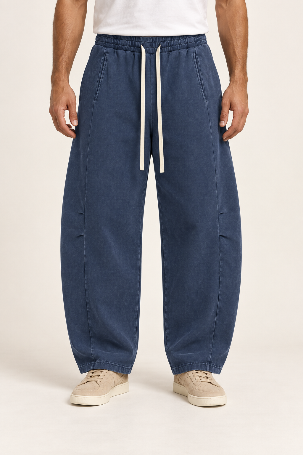 Front hero view of Blue Hour Mineral Wash Barrel Pants in Navy, showing cream drawstrings and curved panelled legs.