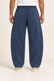 Rear view of Blue Hour Mineral Wash Barrel Pants in Navy, showing the plain washed back and elastic waist.
