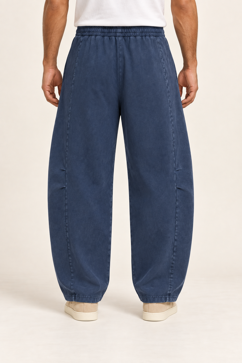 Rear view of Blue Hour Mineral Wash Barrel Pants in Navy, showing the plain washed back and elastic waist.