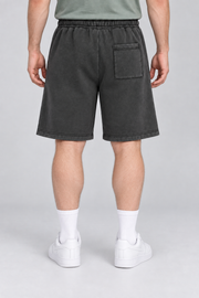 Rear view of Off Duty Vintage Fleece Shorts in Black, showing the single right patch pocket and straight hems.