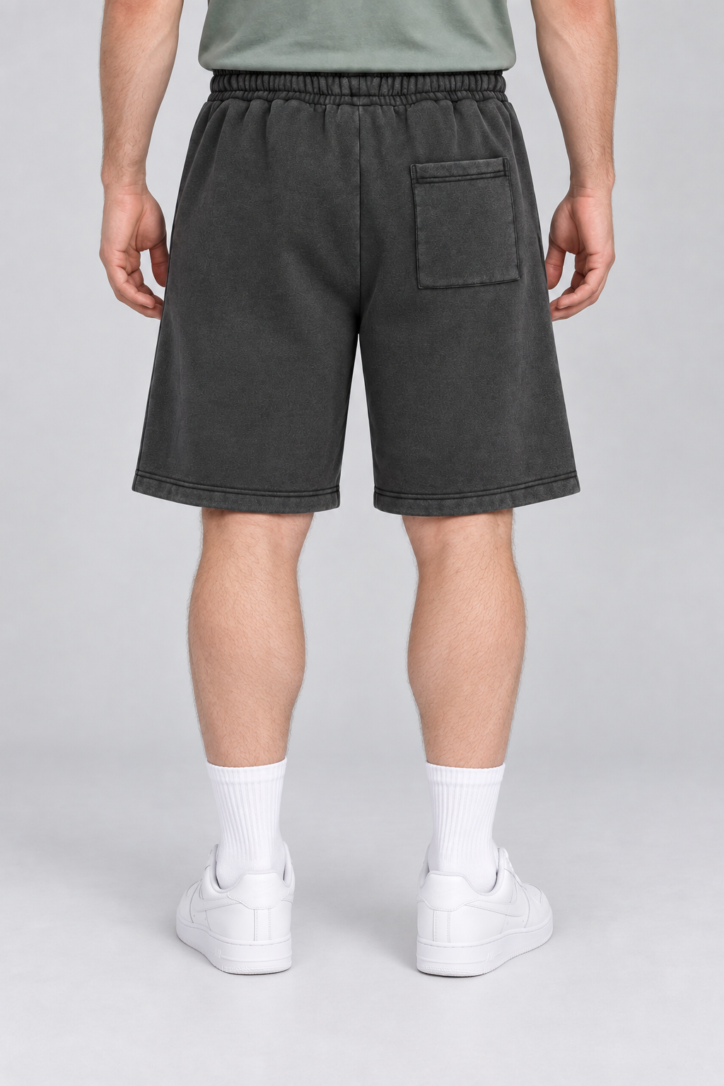 Rear view of Off Duty Vintage Fleece Shorts in Black, showing the single right patch pocket and straight hems.
