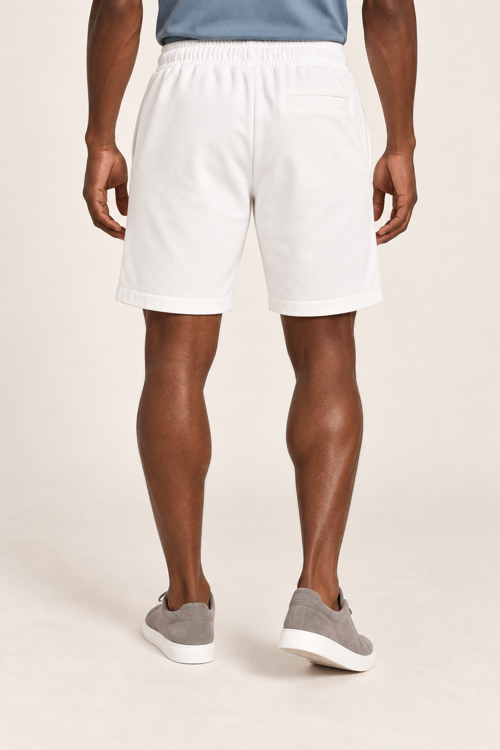 Rear view of Clear Day Cotton Shorts in White, showing the single horizontal welt pocket and plain finish.