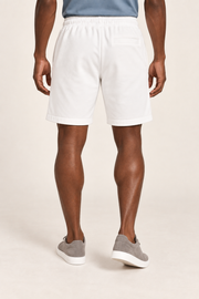 Rear view of Clear Day Cotton Shorts in White, showing the single horizontal welt pocket and plain finish.