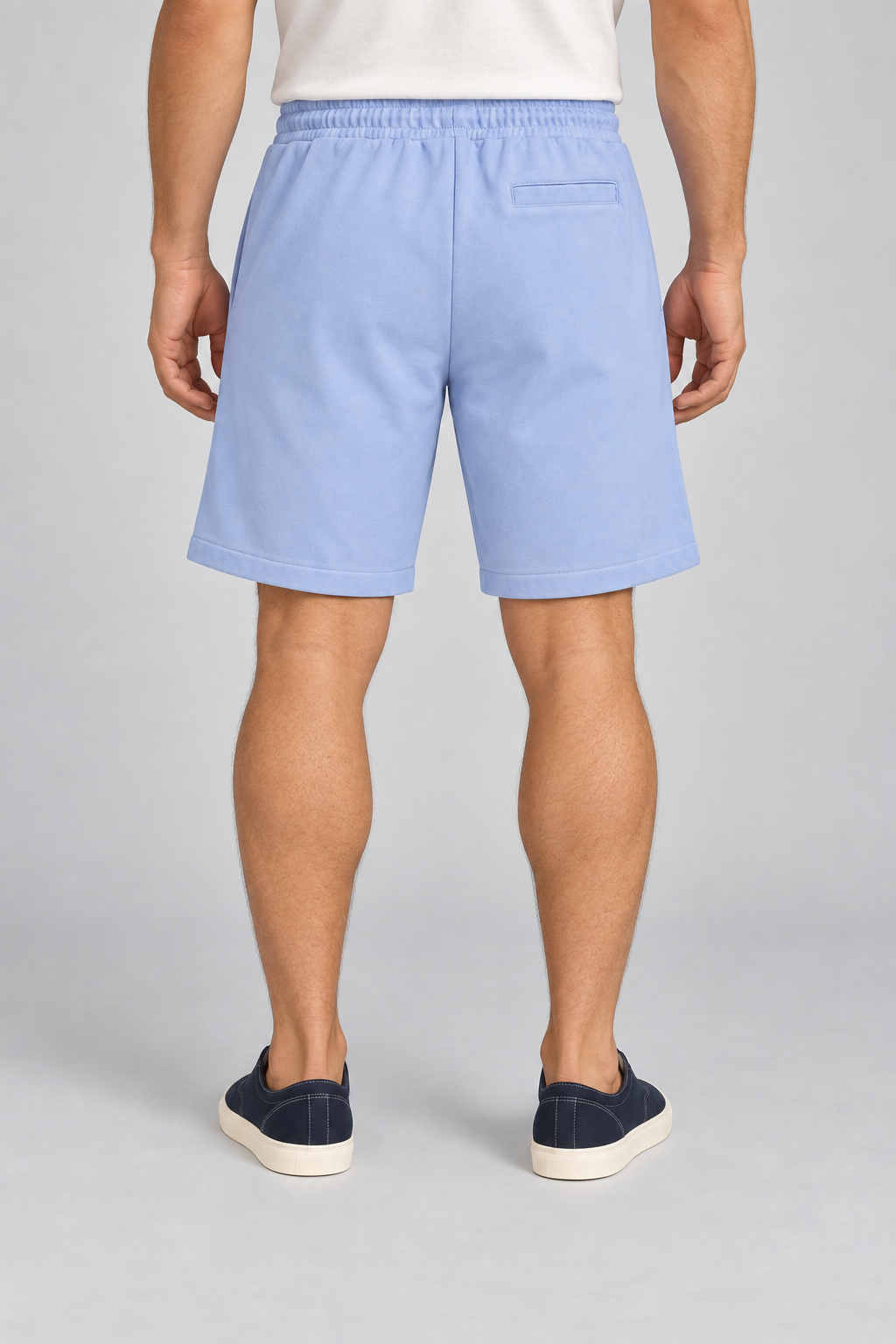 Rear view of Clear Day Cotton Shorts in Sky Blue, showing the single horizontal welt pocket and plain finish.