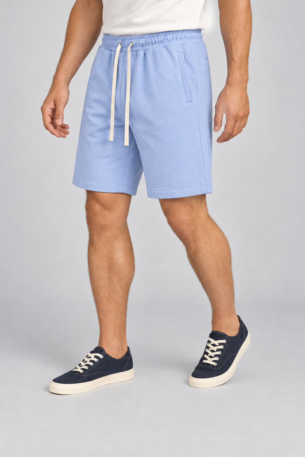 Three-quarter view of Clear Day Cotton Shorts in Sky Blue, showing the loose shape, elastic waist and stitched hems.