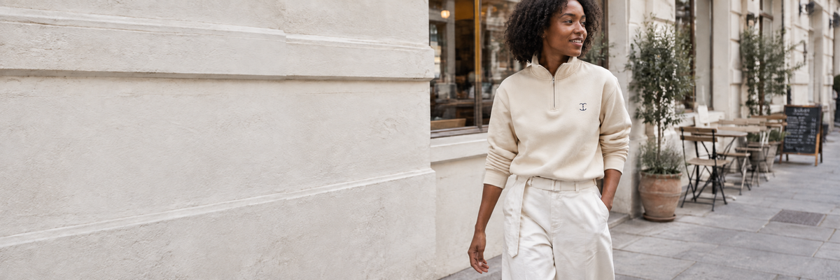 Woman wearing cream TELLS clothing outside a café