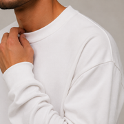 Close detail of Archive Long Sleeve in White showing the crew neck, cuff and cotton texture.