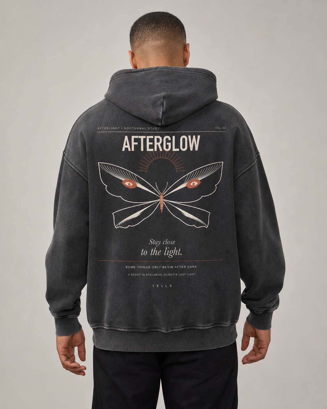 TELLS Afterglow Poster Hoodie in Black, rear studio hero with full Afterglow moth poster