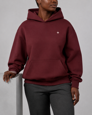 TELLS Dusk Atlas Hoodie in Dull Red, front studio view with ivory Sub Logo