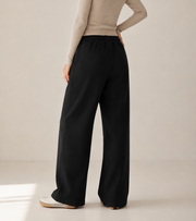 Women’s TELLS Essential Wide-Leg Black Sweatpants — cropped below face