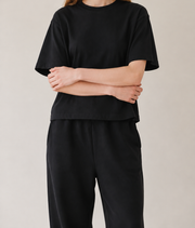 Women’s TELLS Real Flex Black Boxy Tee — cropped below face