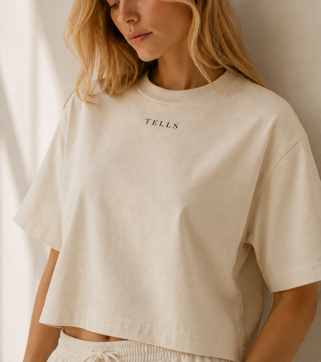 Women’s TELLS Signature Beige Boxy Tee — cropped below face
