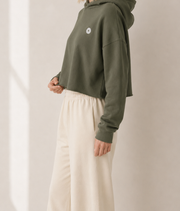 Women’s TELLS Signature Cropped Olive Hoodie — cropped below face