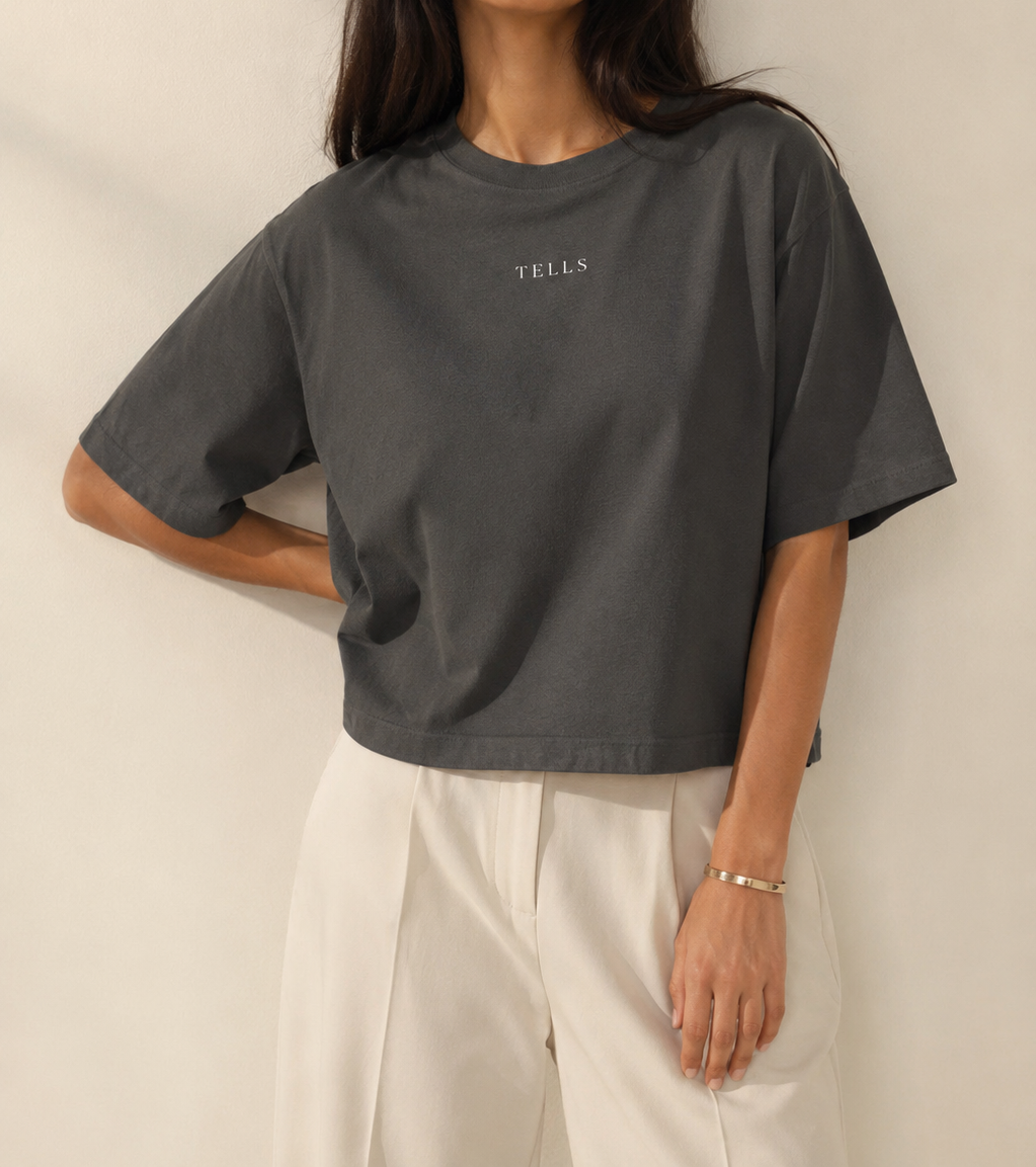 Women’s TELLS Signature Dark Gray Boxy Tee — cropped below face